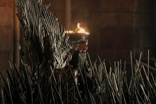 Tom Glynn Carney sitting on the Iron Throne in 