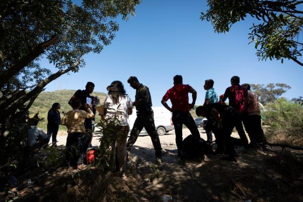 Border Patrol agents talk with migrants seeking asylum on June 5, 2024, near Dulzura, Calif.