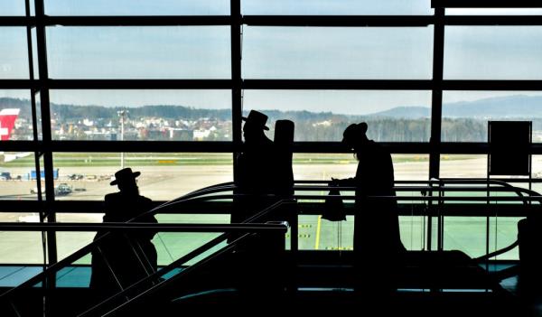 A file photo of a silhouette of Orthodox Jewish individuals in an airport.