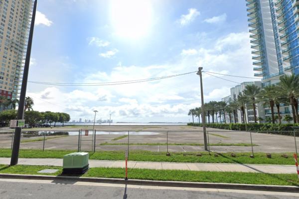 Empty parking lot with large puddle in Miami by the bay.