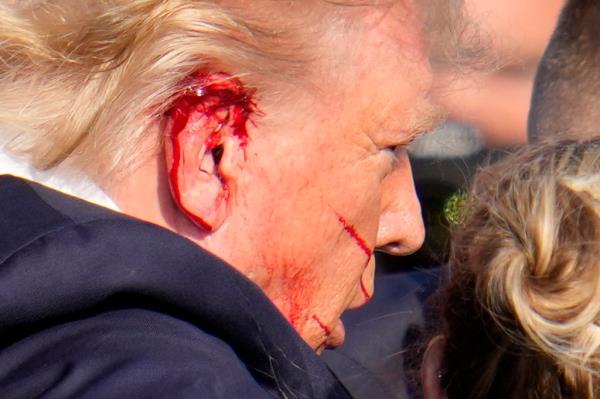 Republican presidential candidate former President Do<em></em>nald Trump is helped off the stage at a campaign event in Butler, Pa., on Saturday, July 13, 2024.