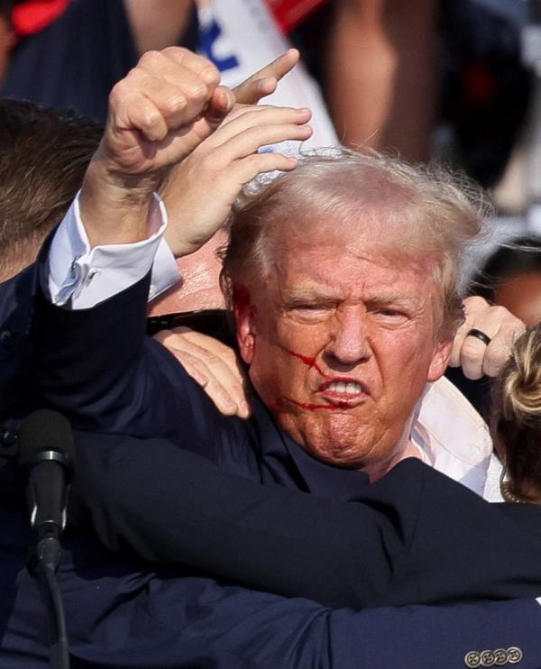 Republican presidential candidate and former U.S. President Do<em></em>nald Trump is assisted by security perso<em></em>nnel after gunfire rang out during a campaign rally at the Butler Farm Show in Butler, Pennsylvania, U.S., July 13, 2024.