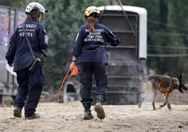 Members of the FEMA Urban Search and Rescue Task Force searching a flood damaged area in Asheville following Hurricane Helene on Oct. 4, 2024.