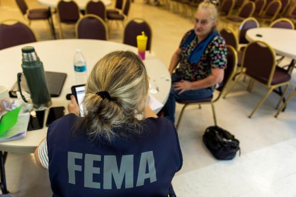 A FEMA worker speaking with a resident in Marion, North Carolina on Oct. 5, 2024.