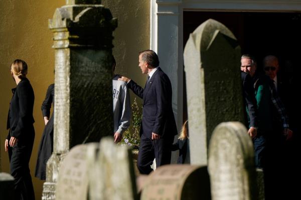 Hunter Biden and family members walking towards Beau Biden's gravesite at St. Joseph on the Brandywine Catholic Church on the anniversary of his death, with U.S. President Joe Biden present