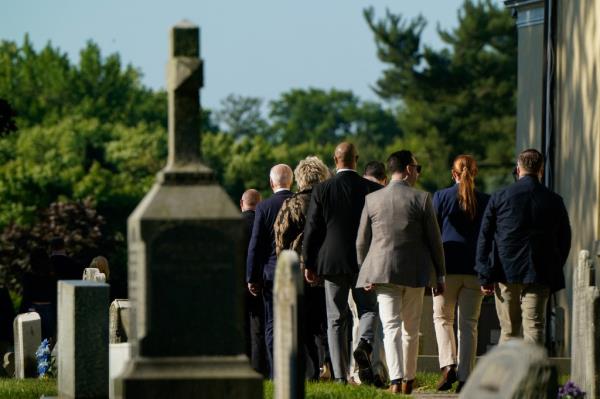 U.S. President Joe Biden with family walking towards the gravesite of late son Beau at St. Joseph on the Brandywine Catholic Church, on the anniversary of Beau's death