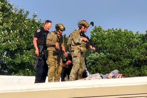 Officers surround the body of Thomas Matthew Crooks after he was killed at former President Do<em></em>nald Trump's campaign rally in Butler, PA on July 13, 2024.