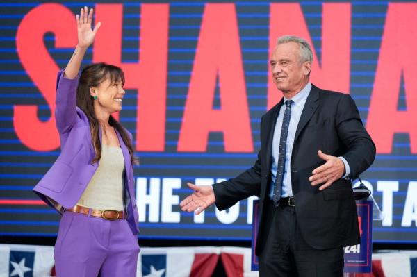 Presidential candidate Robert F. Kennedy Jr. right, stands on stage with Nicole Shanahan, after announcing her as his running mate, during a campaign event, Tuesday, March 26, 2024