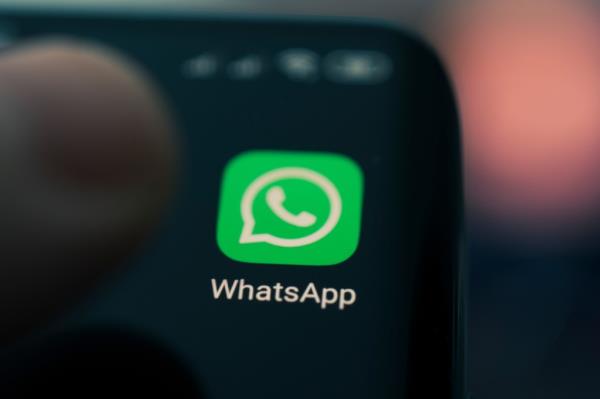 WhatsApp app icon displayed on the screen of a black smartphone