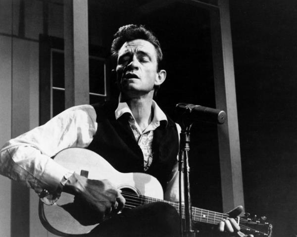 Johnny Cash, American rock and country singer-songwriter, playing guitar circa 1965