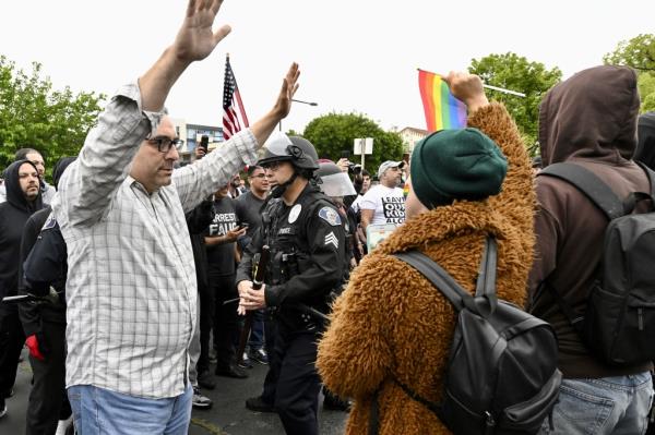 Co<em></em>nservative groups andLGBTQ+ rights supporters protest as police try to maintain order outside the Glendale Unified School District offices in Glendale, Calif., Tuesday, June 6, 2023.