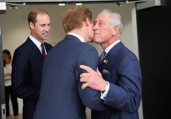 King Charles kisses son Prince Harry.