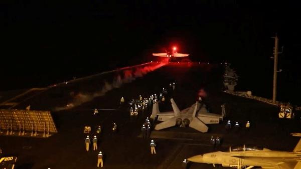 A US armed forces jet takes off from a aircraft carrier to co<em></em>nduct air strikes against Iran-backed military targets in Yemen during an overnight attack.