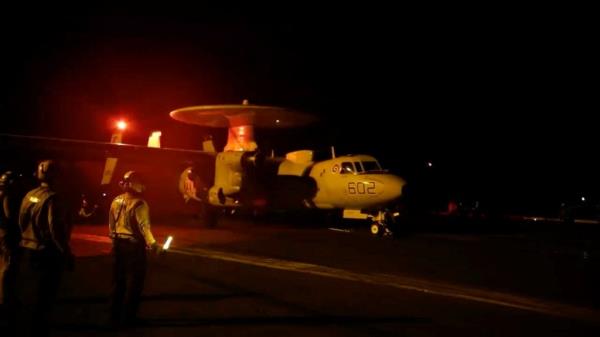 A US aircraft stands ready on the flight deck of an aircraft carrier in an undisclosed location before taking off to join an operation against military targets in Yemen.