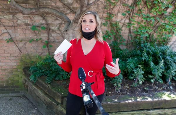 Salon owner Shelley Luther holding a citation and speaking to media after refusing to close her reopened Salon A la Mode in Dallas, amid virus outbreak.