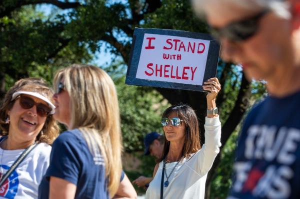 Kristi Lisenbee from Keller, Texas, protesting with sign outside Dallas Municipal Court for release of jailed salon owner Shelley Luther