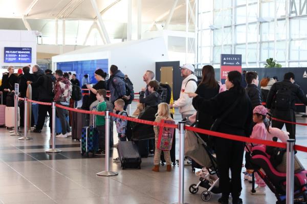 People preparing to travel for Thanksgiving at JFK Airport.