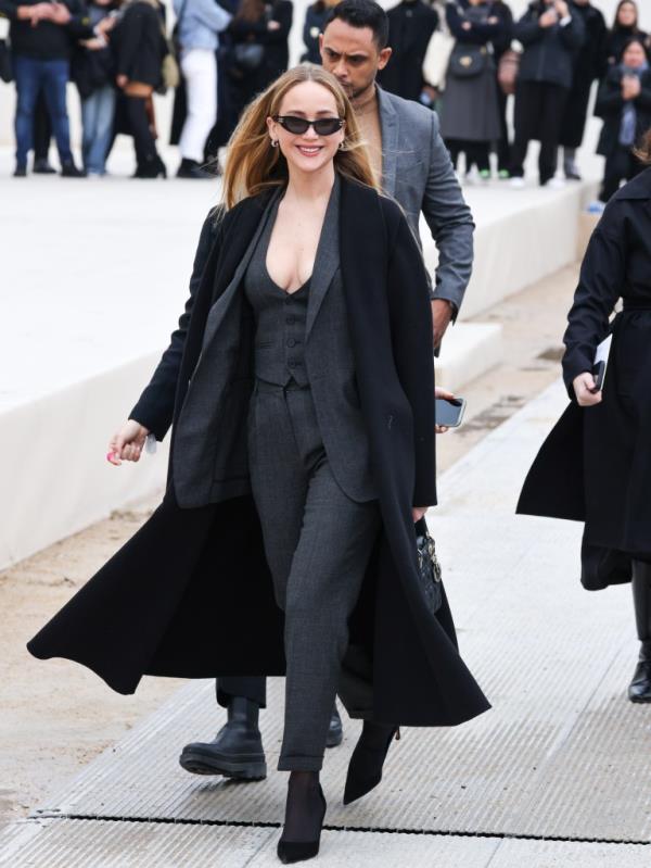 Jennifer Lawrence in a suit and sunglasses arriving at the Christian Dior Womenswear Fall/Winter 2024-2025 show during Paris Fashion Week