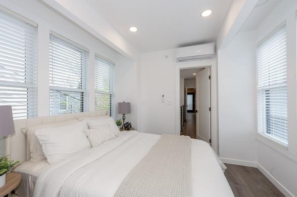 The second-floor bedroom is flooded with natural light.