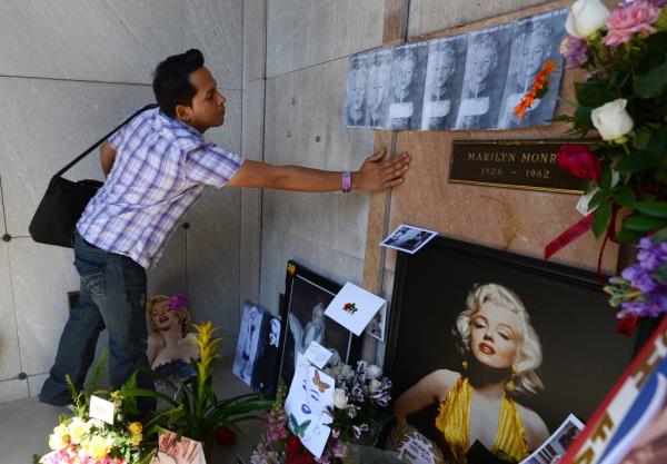 A diehard fan from Nicaragua pays his respects at the crypt of Marilyn Monroe.