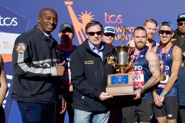 Tarik Sheppard and Tom Do<em></em>nlon in a photo with marathon runners.