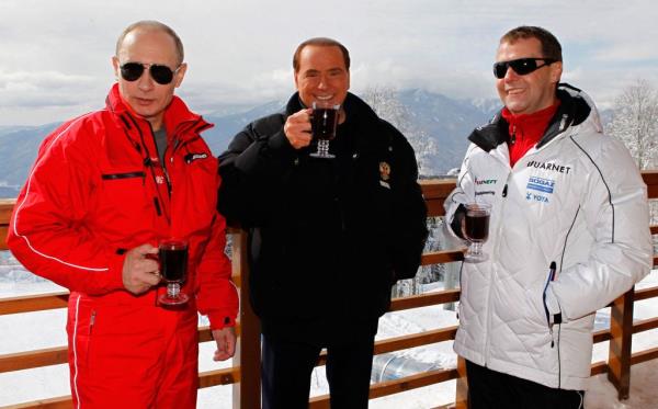 In this file photo taken on March 08, 2012 Russia's outgoing President Dmitry Medvedev (R) and newly elected president Vladimir Putin (L) meet with former Italy's Prime minister Silvio Berlusconi at the Rosa Khutor alpine ski resort in Krasnaya Polyana