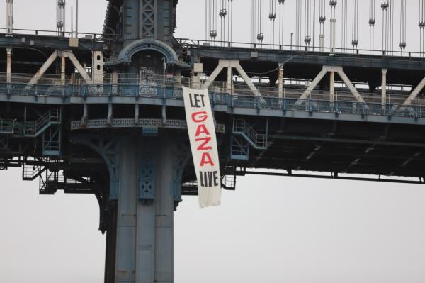 Protesters also unfurled a banner demanding “Let Gaza Live”