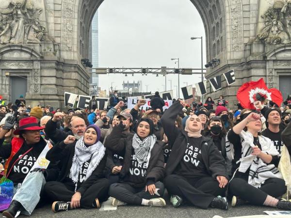 Protesters sit and chant on the Manhattan Bridge.