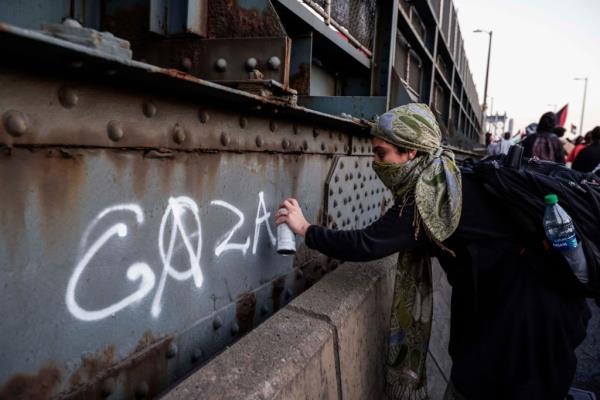 A woman spray paints 