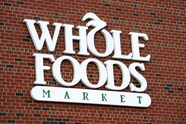 Whole Foods Market sign on a brick wall in Edgewater, NJ, taken on May 28, 2024