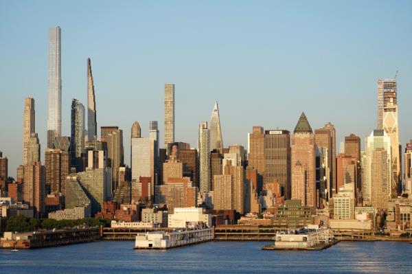 View of the New York City skyline at golden hour from Weehawken, NJ, showcasing commercial and office buildings on May 31, 2024