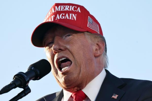 Trump speaks into a microphone at his rally in Coachella, Calif..