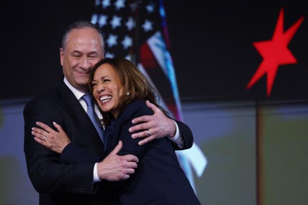 Vice President Kamala Harris embracing her husband Doug Emhoff at the Democratic Natio<em></em>nal Co<em></em>nvention in Chicago, Illinois