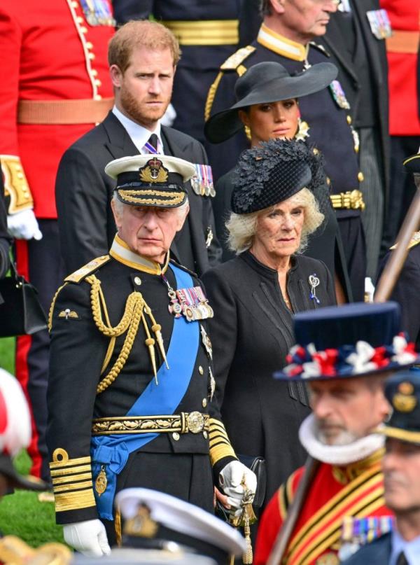 Members of the Royal Family, including Prince William, Prince Harry, and King Charles III, standing near Wellington Arch during the State Funeral of Queen Elizabeth II in London, England.