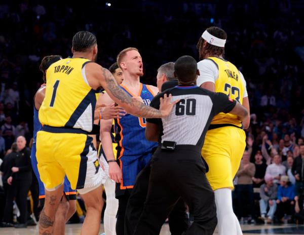  New York Knicks guard Do<em></em>nte DiVincenzo #0 and Indiana Pacers center Myles Turner #33 exchange words as they are held back by referees during the third quarter.