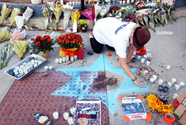 Elena Colombo creates a Star of David at a makeshift memorial at the site of an altercation between 69-year-old Paul Kessler, who was Jewish, and pro-Palestinian protestor on November 7, 2023 in Thousand Oaks, California.