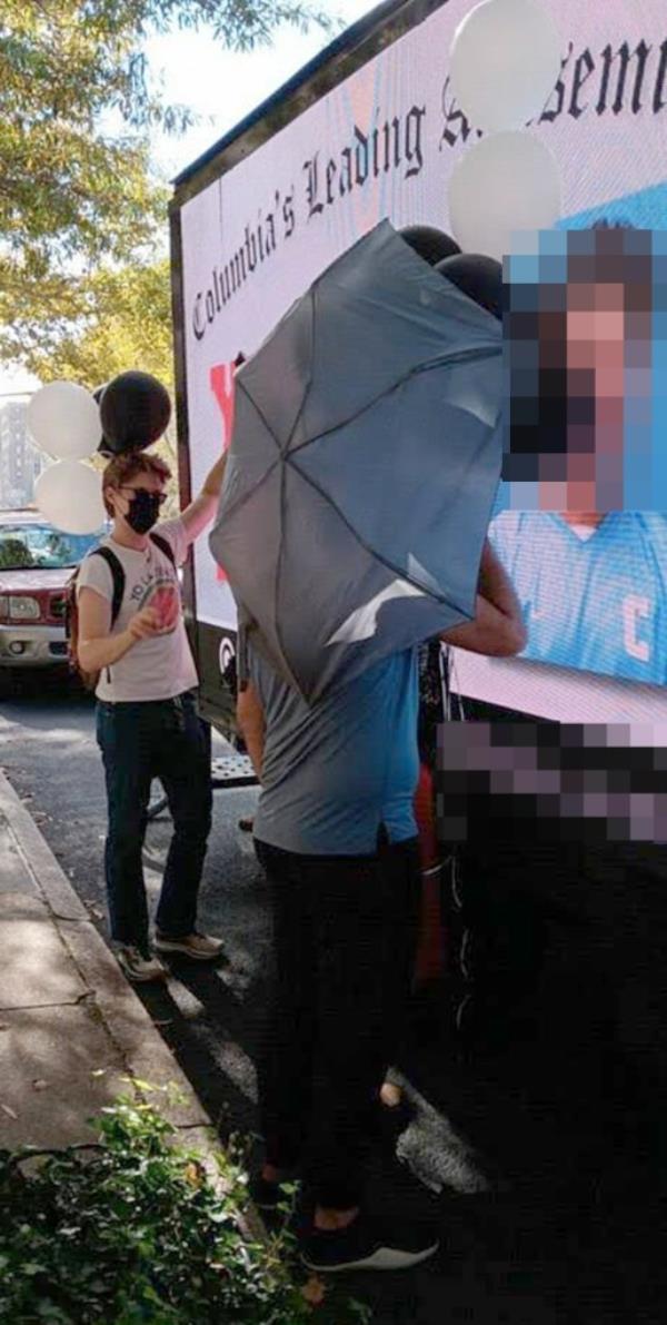 Some people attempting to block the truck's display even held balloons.