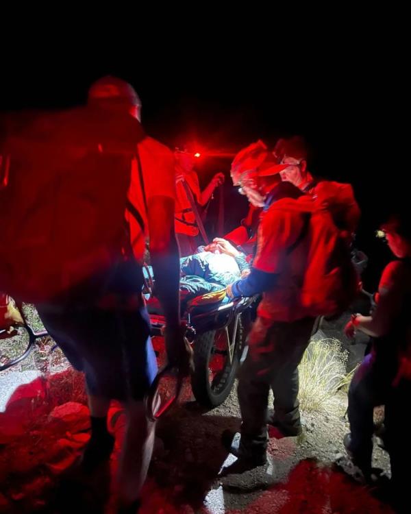 Rescuers strapping the victim.