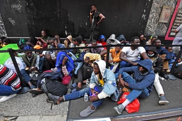 Migrants waiting outside of the Roosevelt Hotel in Manhattan on July 31, 2023.