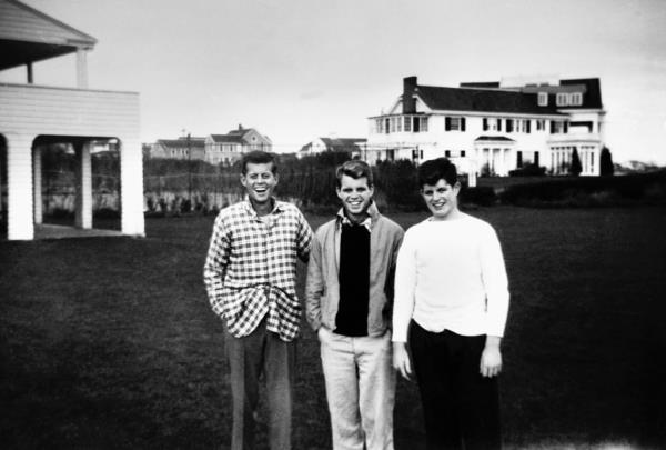 Three of the Kennedy brothers, John, Robert and Ted in their teens, stand together at their family compound in Hyannisport