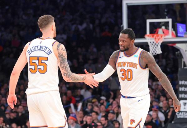 New York Knicks forward Julius Randle #30 is greeted by New York Knicks center Isaiah Hartenstein #55 on the court 