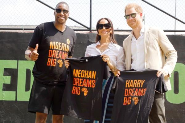 Prince Harry, Duke of Sussex and Meghan, Duchess of Sussex holding up perso<em></em>nalized T-shirts with 'Harry Dreams Big' and 'Meghan Dreams Big' written on them during their visit to Ilupeju Senior Grammar School in Lagos, Nigeria.