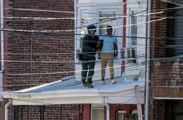 Police remove people from a home in Trenton New Jersey,