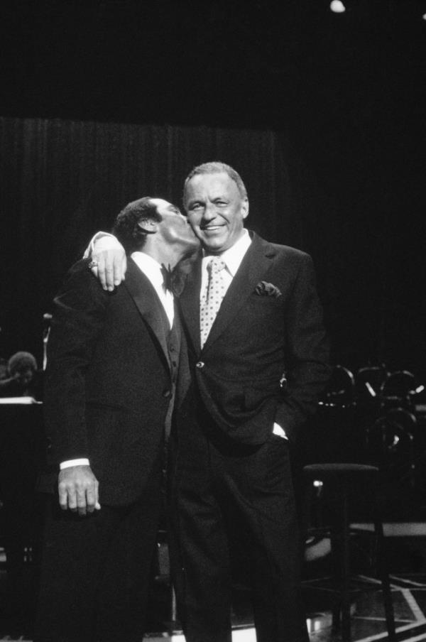 Paul Anka kisses Frank Sinatra during the United Cerebral Palsy annual telethon.