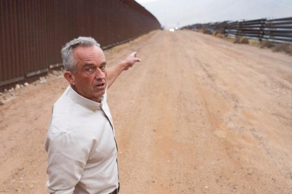 Independent presidential candidate Robert F. Kennedy Jr. points with a finger, as he tours the U.S.-Mexico border fence, near Sierra Vista, Arizona, U.S. February 6, 2024