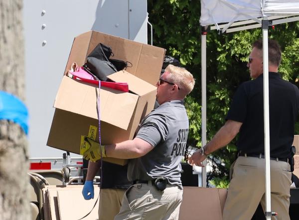 NY State police along with Suffolk County police remove items from the home of Rex Heuermann.