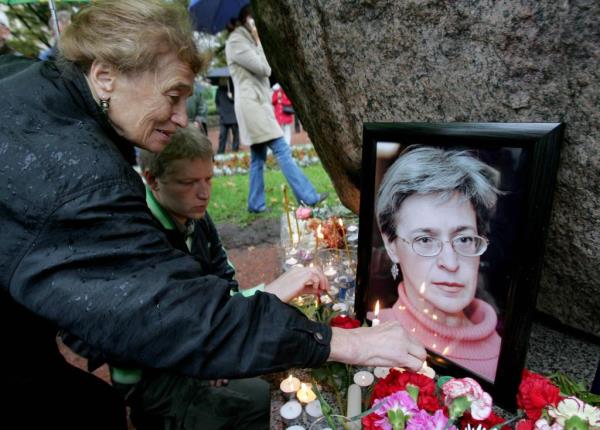 People light candles next to a portrait of  Anna Politkovskaya during a rally in St. Petersburg shortly after she was killed.