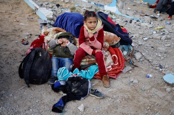 Children rest outside as Palestinian arrive in Rafah after they were evacuated from Nasser hospital in Khan Younis on Feb. 15, 2024. 