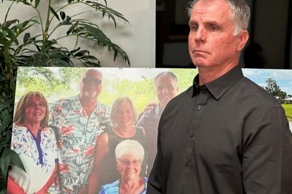 Bill Serge stands next to a photo of his 85-year-old mother during a press co<em></em>nference on Thursday in West Palm Beach, Fla.