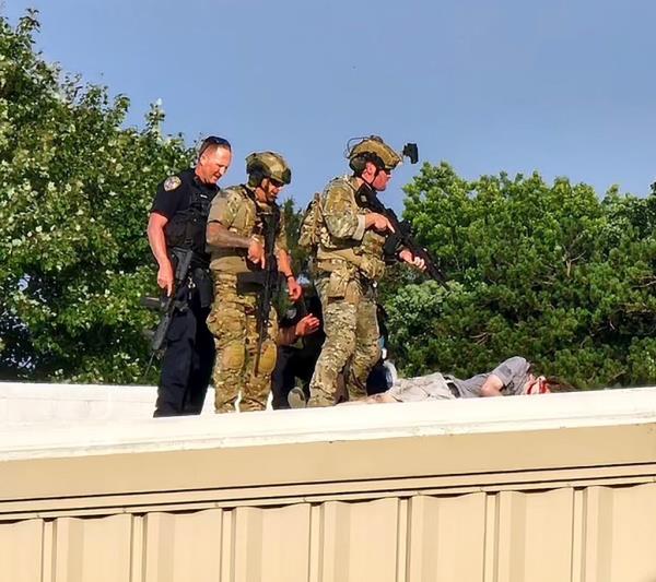 Officers stand over the body of shooter Thomas Matthew Crooks after an assassination attempt on former President Do<em></em>nald Trump during a campaign rally in Butler, PA, Saturday, July 14, 2024.